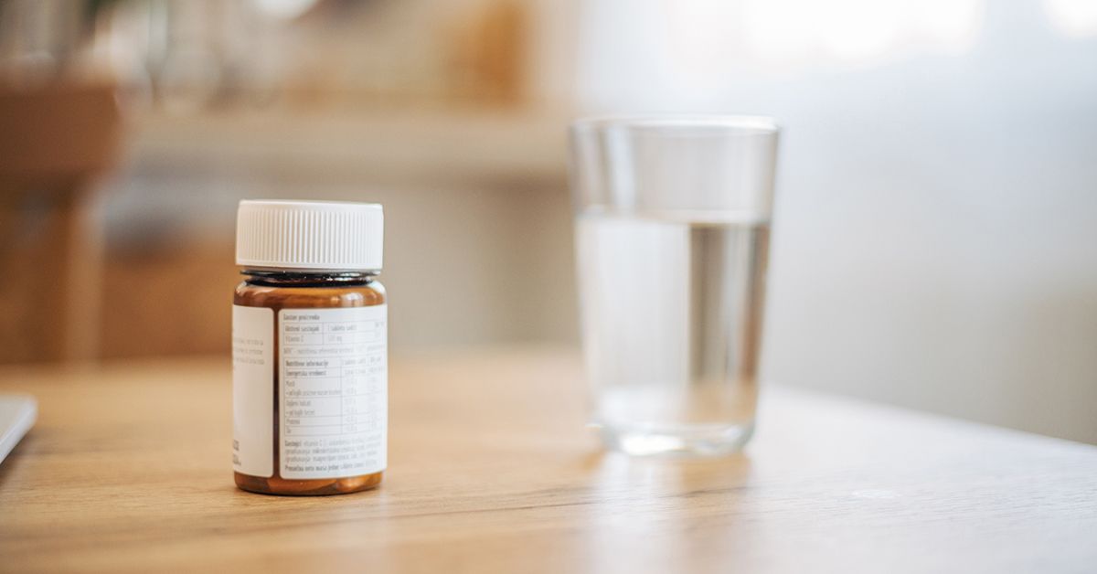 Close-up of various supplement capsules and herbal components used in natural MS therapy.