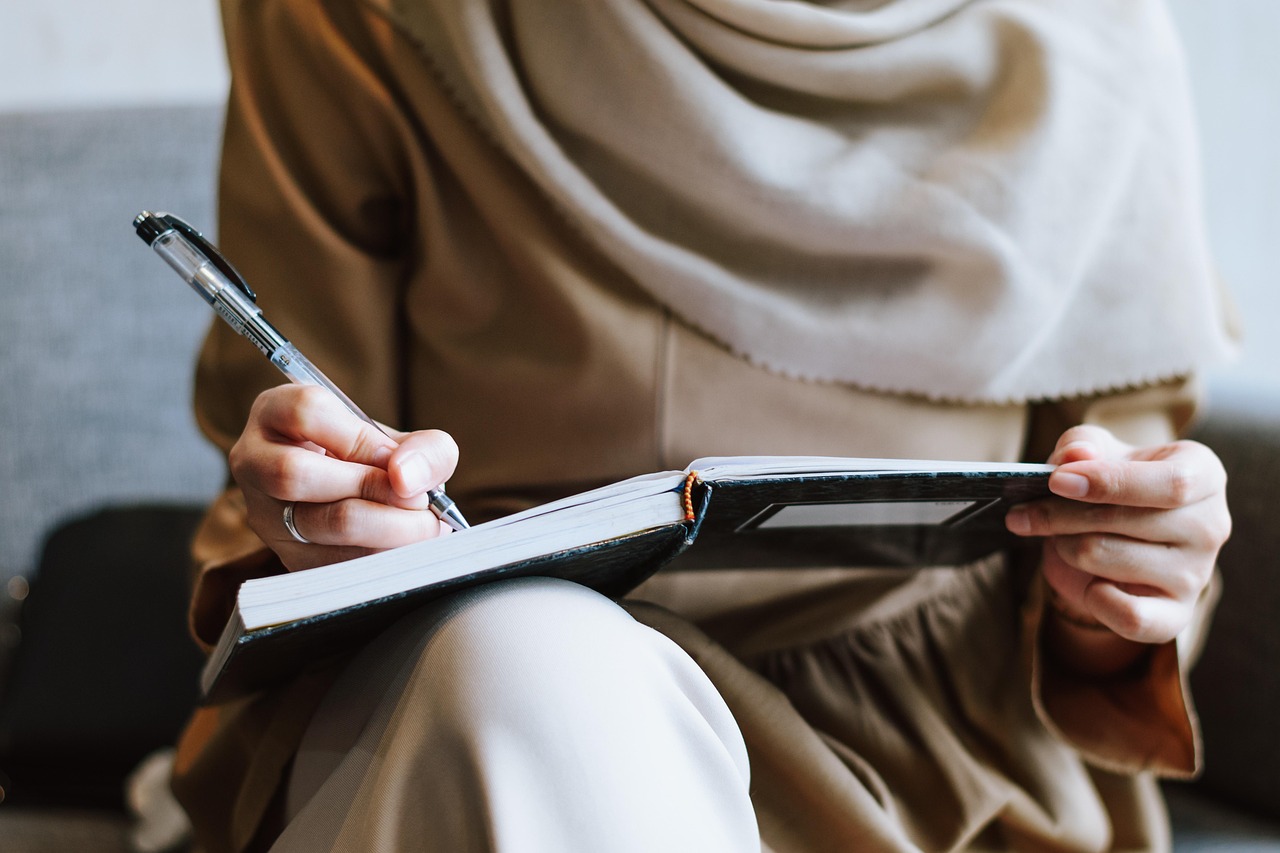 A woman working on a laptop with a look of deep concentration and clarity