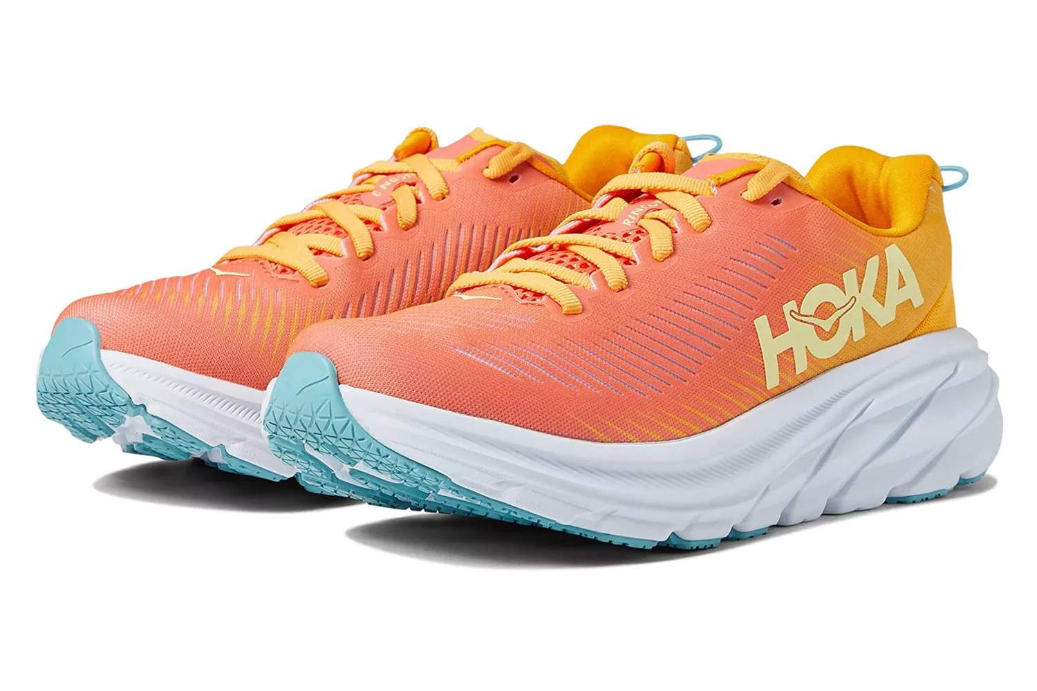 HOKA One One Rincon 3 shoes in bright orange and yellow, showing the thick yet lightweight midsole designed for cushioning without weight.