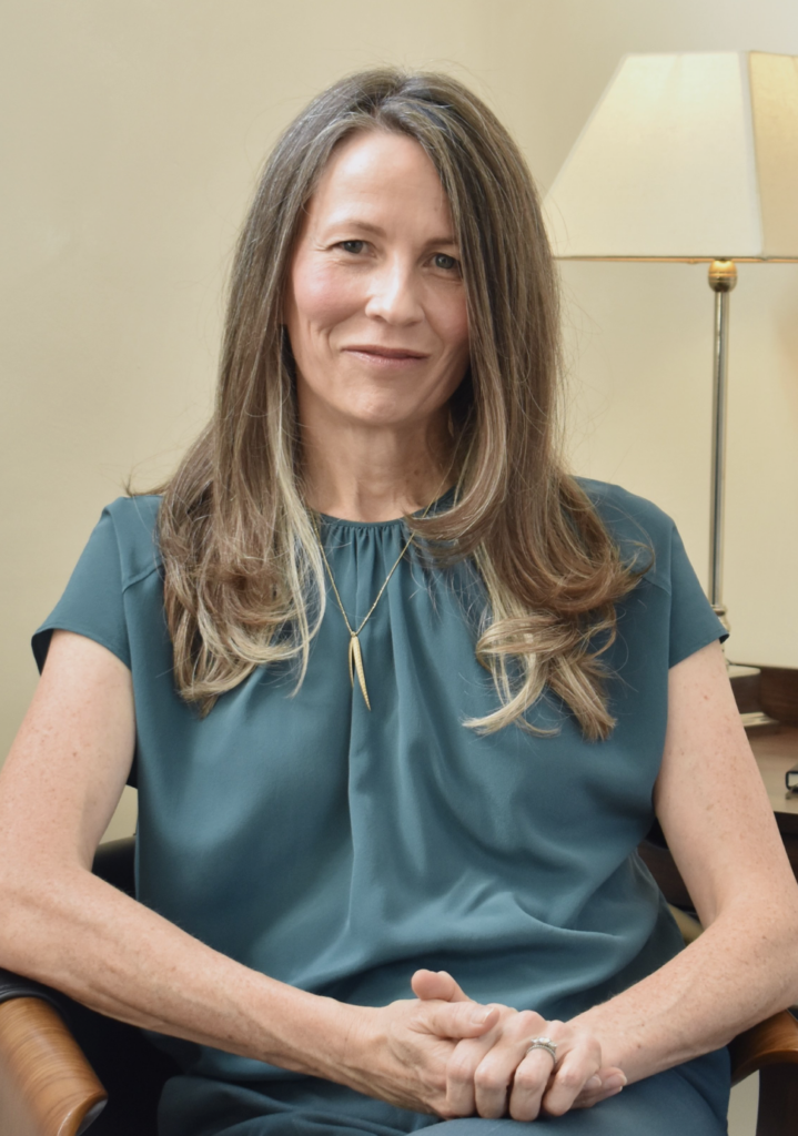 A woman in a calm, professional consultation setting focused on mental wellness.