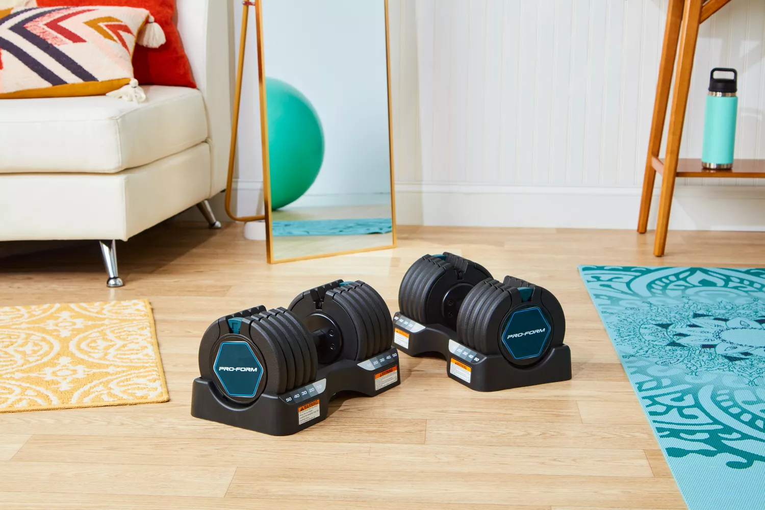 ProForm Select-a-Weight dumbbells on their storage bases in a home workout area.
