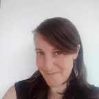 A portrait of a fitness professional or coach against a neutral background.