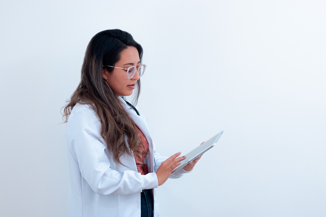 A doctor and patient having a supportive conversation in a clinical setting.
