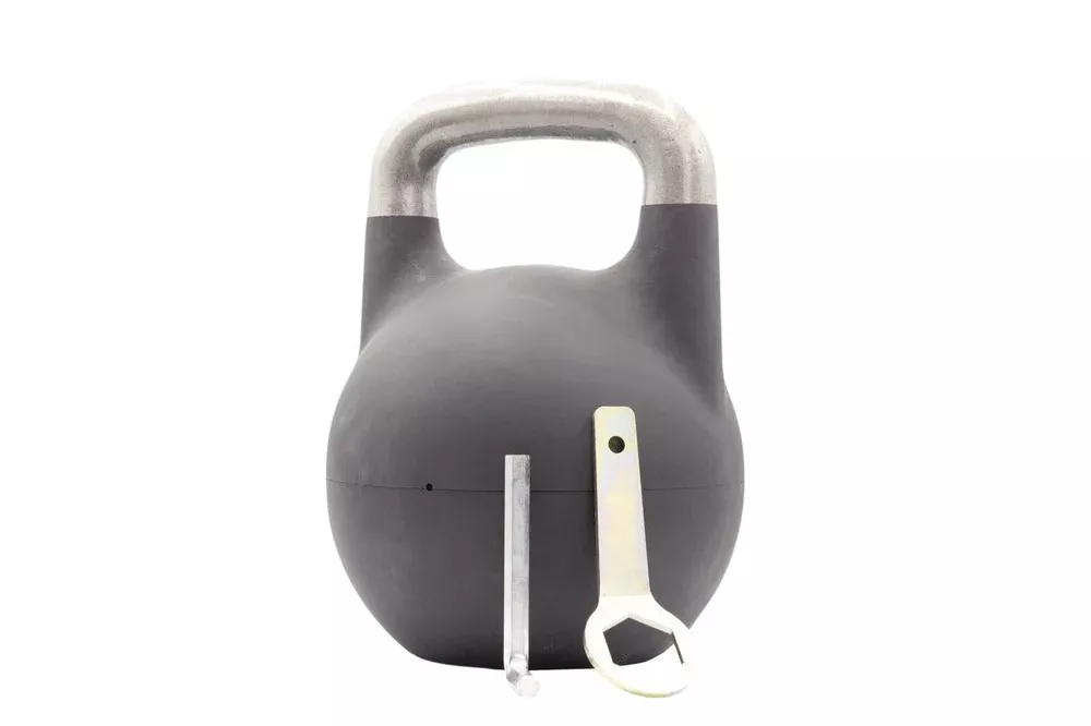 A black competition-style adjustable kettlebell with a polished metal handle and adjustment tools.