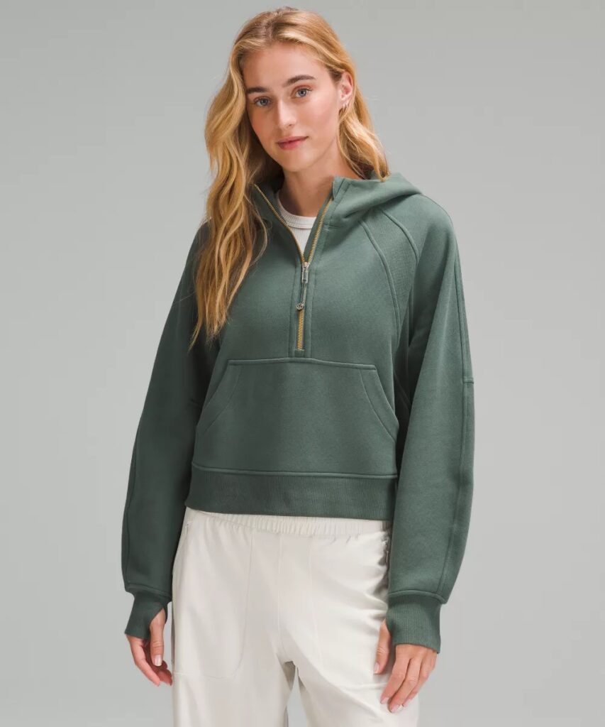 An oversized dark forest green half-zip hoodie.