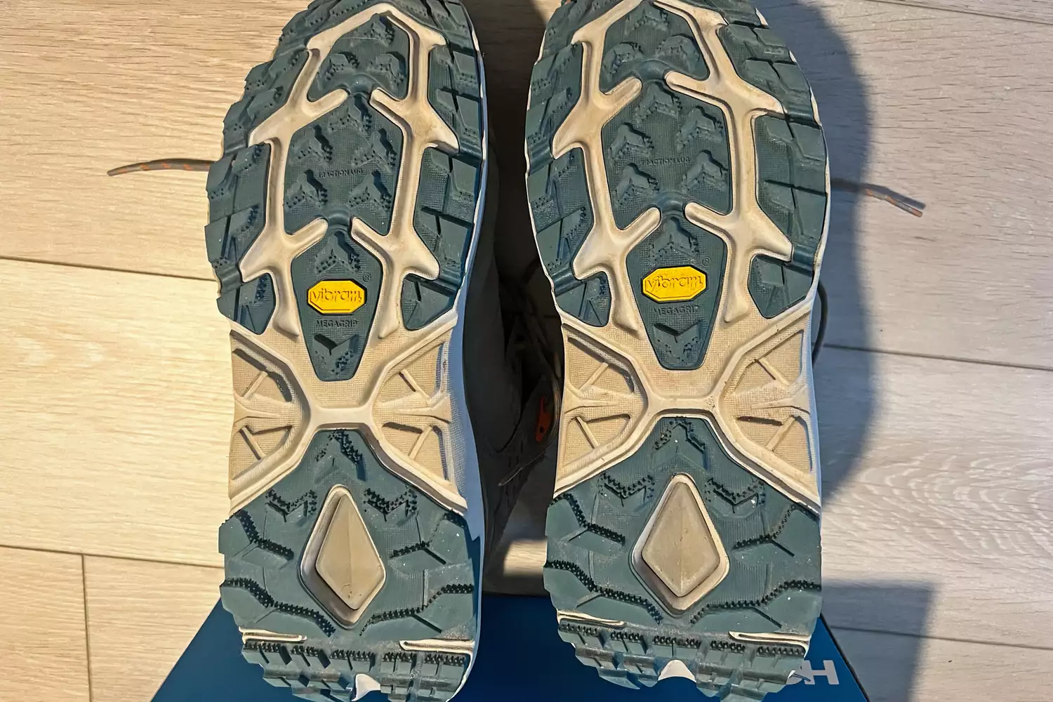 Close-up view of the Vibram Megagrip outsoles on a pair of Hoka shoes.