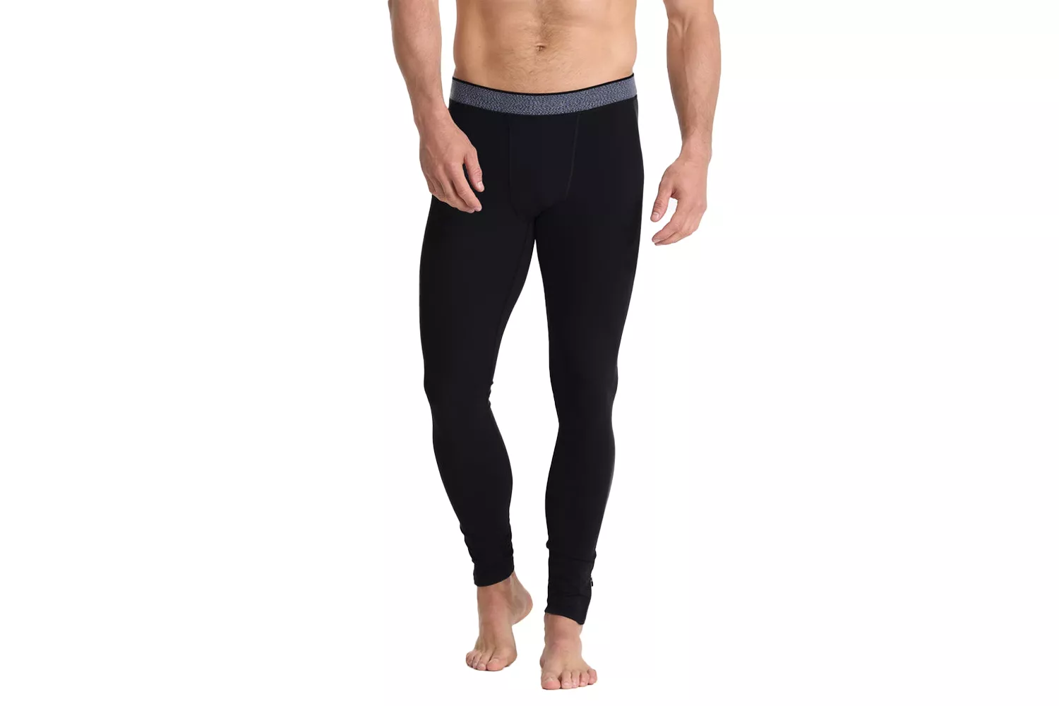 A male model wearing black compression tights with a patterned waistband against a white background.