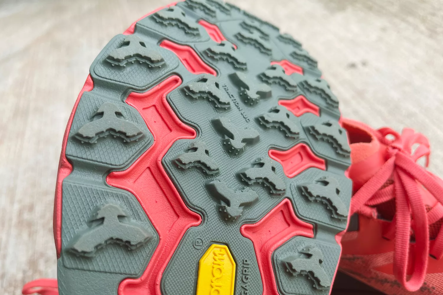 Close-up of a Hoka trail shoe outsole featuring aggressive Vibram Megagrip traction lugs.