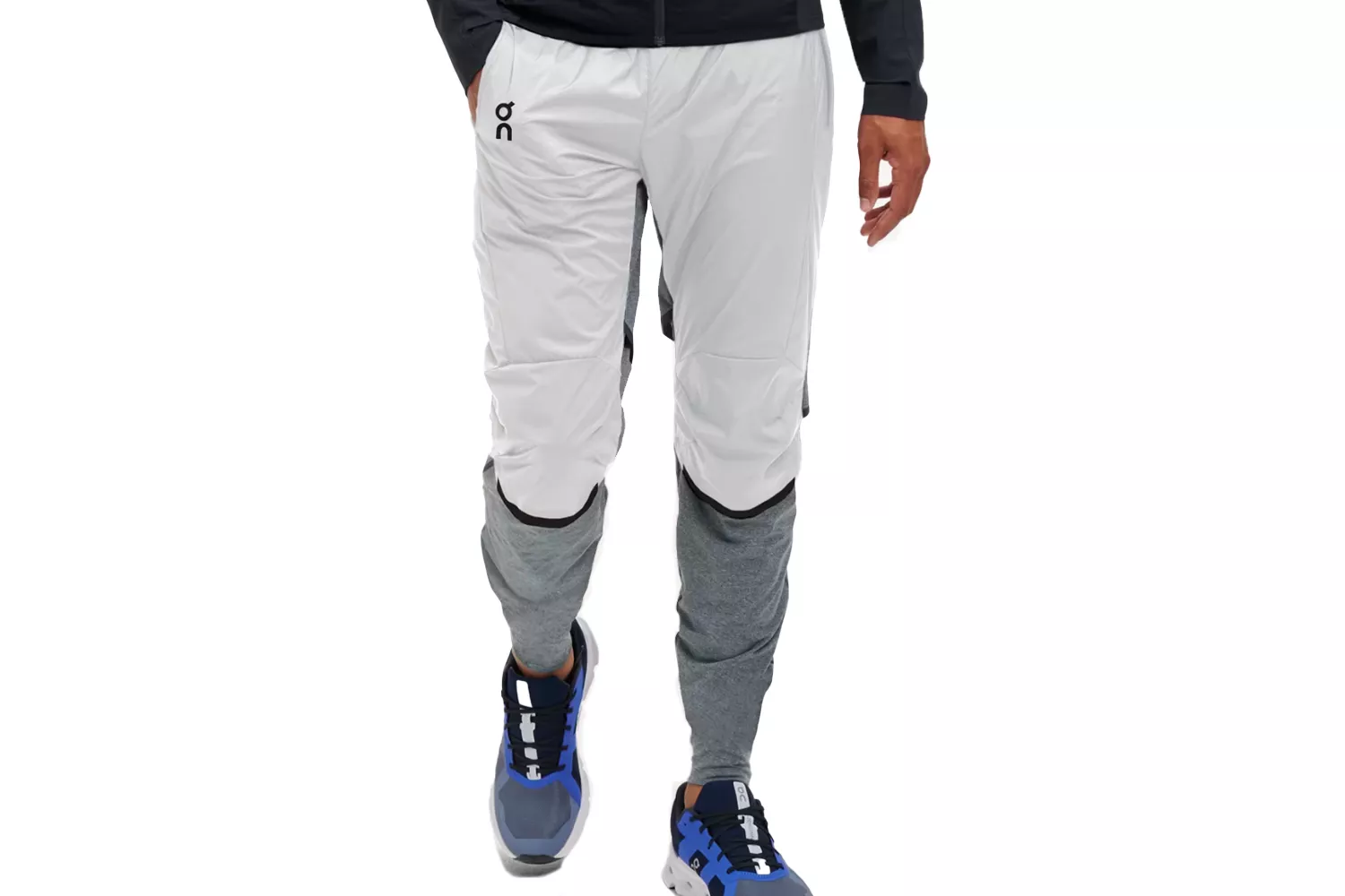 A person modeling On Running hybrid athletic pants featuring a shell fabric and thermal-lined legs.
