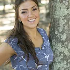 A healthy, smiling woman outdoors, symbolizing the success of a hormone balancing lifestyle.