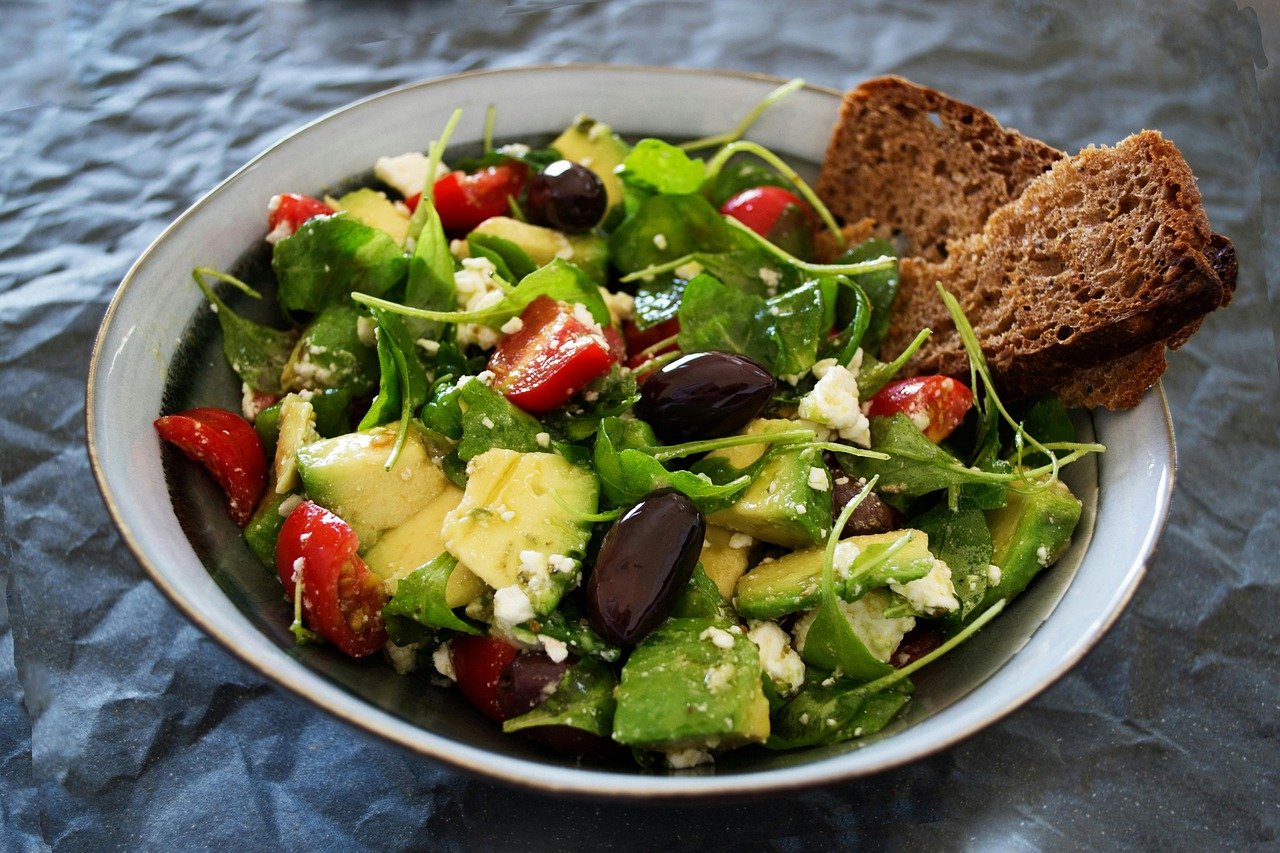 A fresh green salad with avocado and healthy dressing