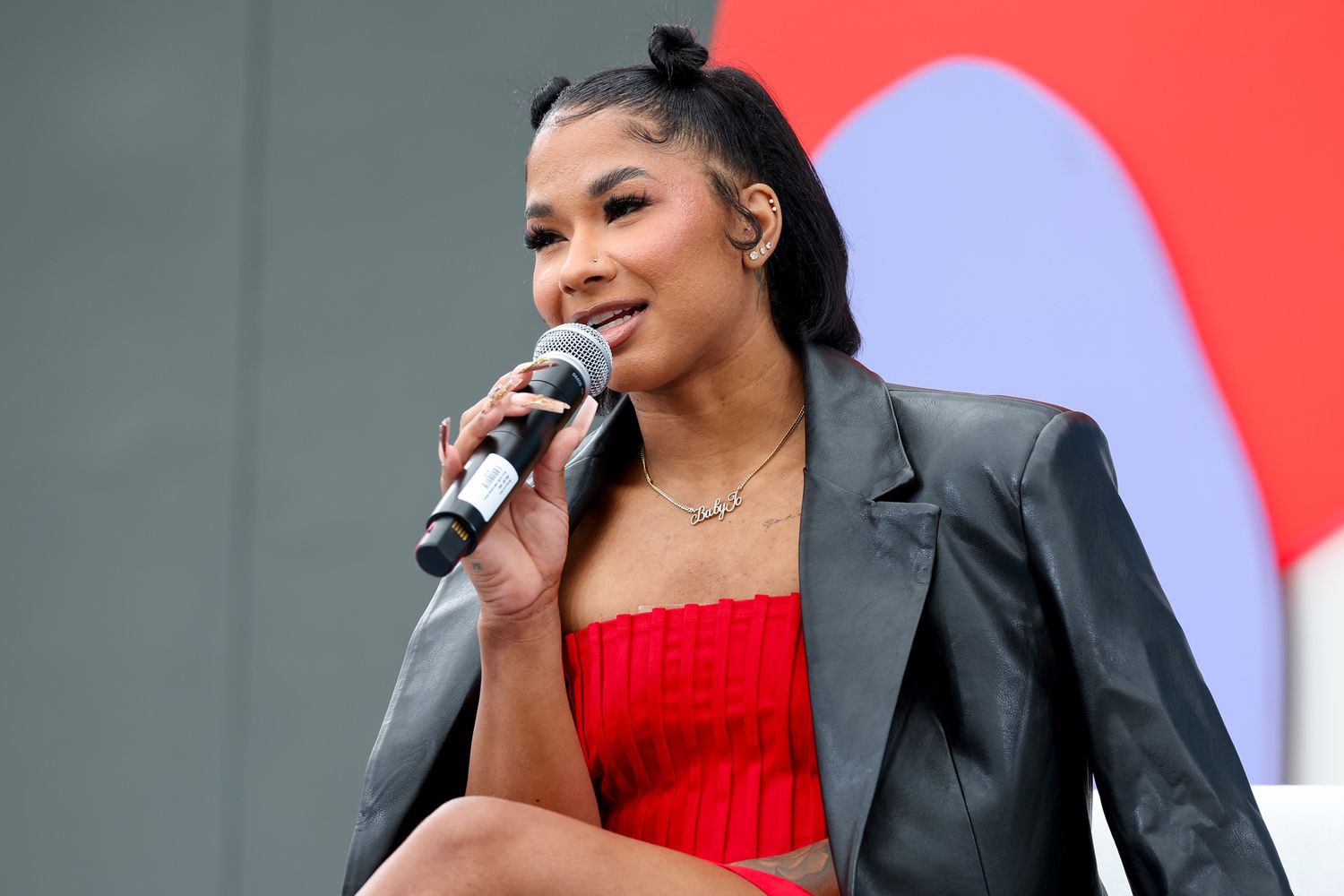 Jordan Chiles speaking onstage at the Teen Vogue Summit 2024 regarding health and empowerment.