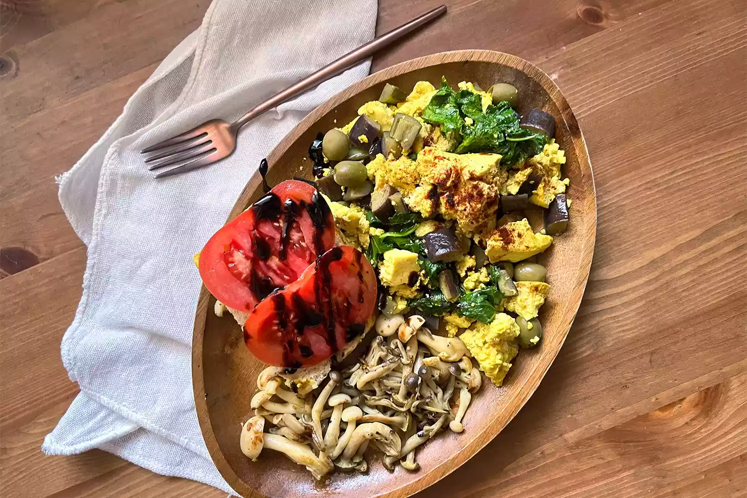 A colorful tofu scramble bowl with fresh vegetables.