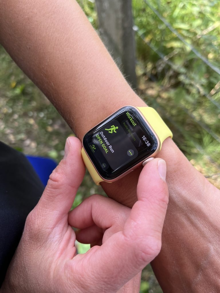 A runner looking ahead on a winding mountain trail, focusing on the path ahead.
