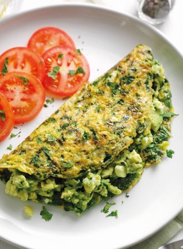 A close-up of a vibrant savory tofu scramble with bell peppers and turmeric.