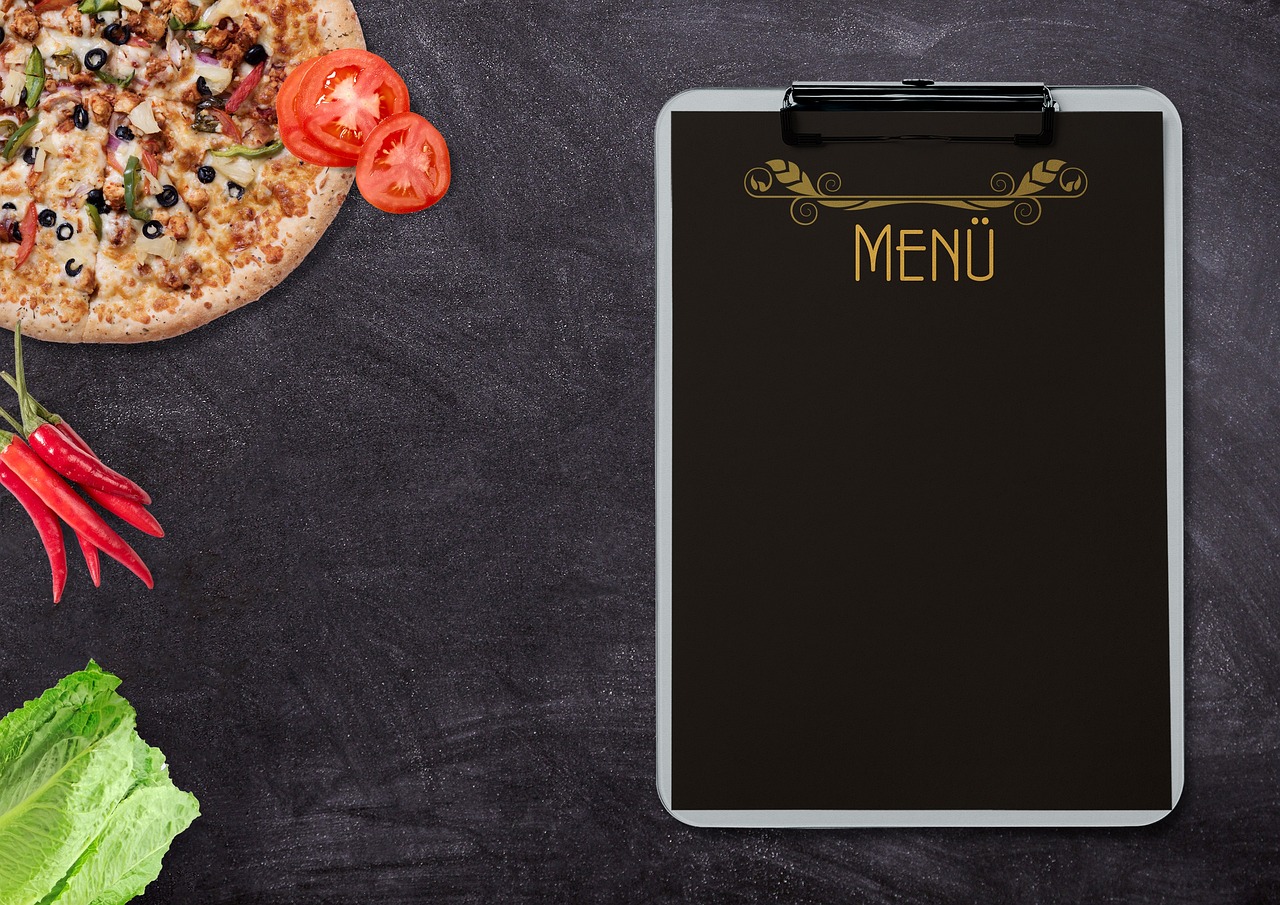 Glass containers filled with prepared healthy meals like roasted vegetables and quinoa.