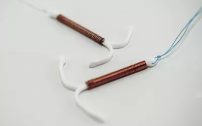 Two intrauterine devices with copper coils shown on a white background for comparison.