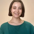 A professional-looking woman smiling, representing a health or wellness consultant.