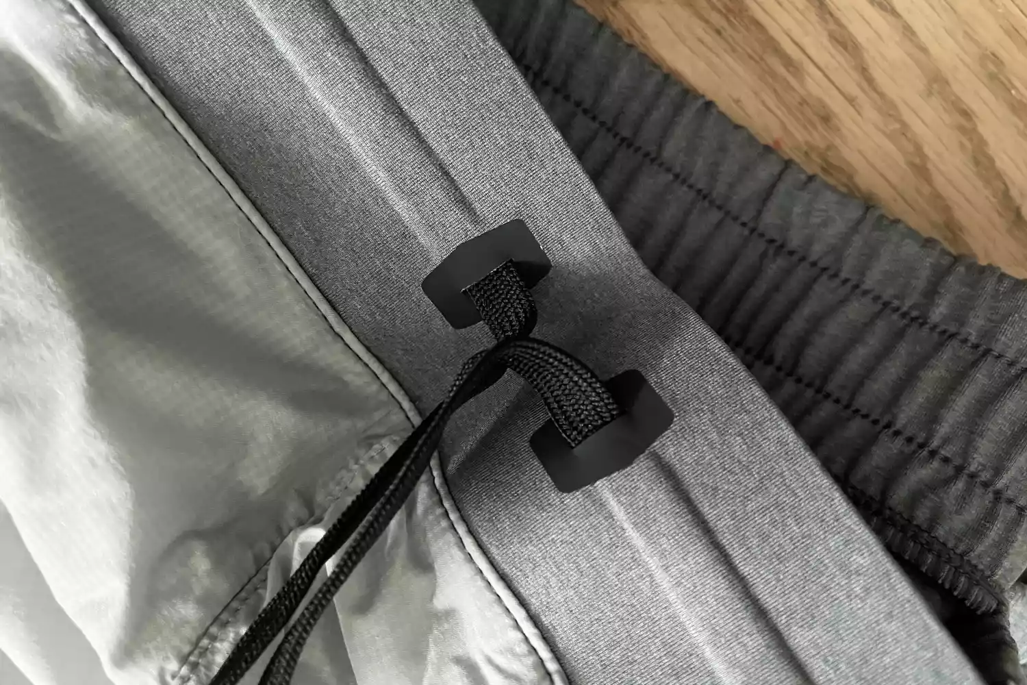 Close-up of a drawstring waistband on a pair of athletic running pants.
