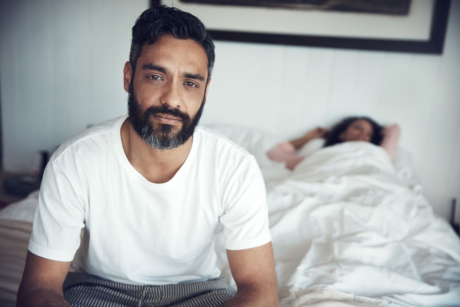 Close-up of a person looking stressed or contemplative, representing anxiety induced erectile dysfunction.