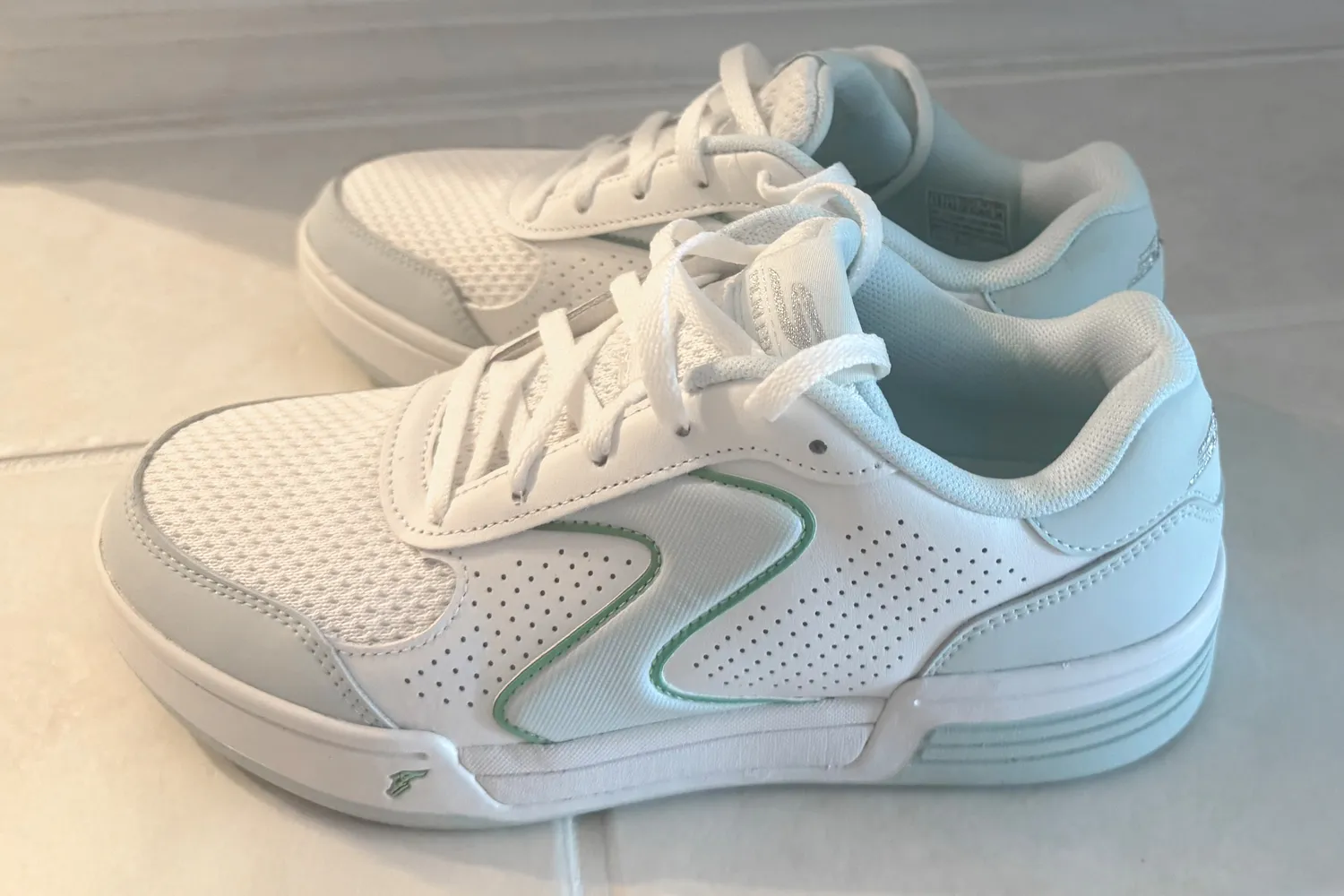 Side profile of a white Skechers Viper Court Classic pickleball shoe with green accents.