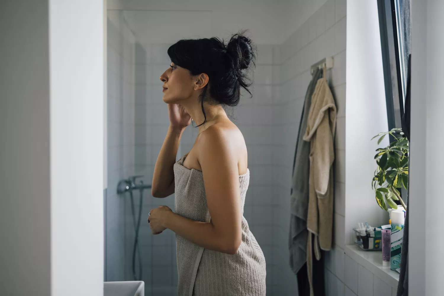 A mature woman engaging in a self-care routine, representing the demographic focus for heart disease symptoms in women over 50.
