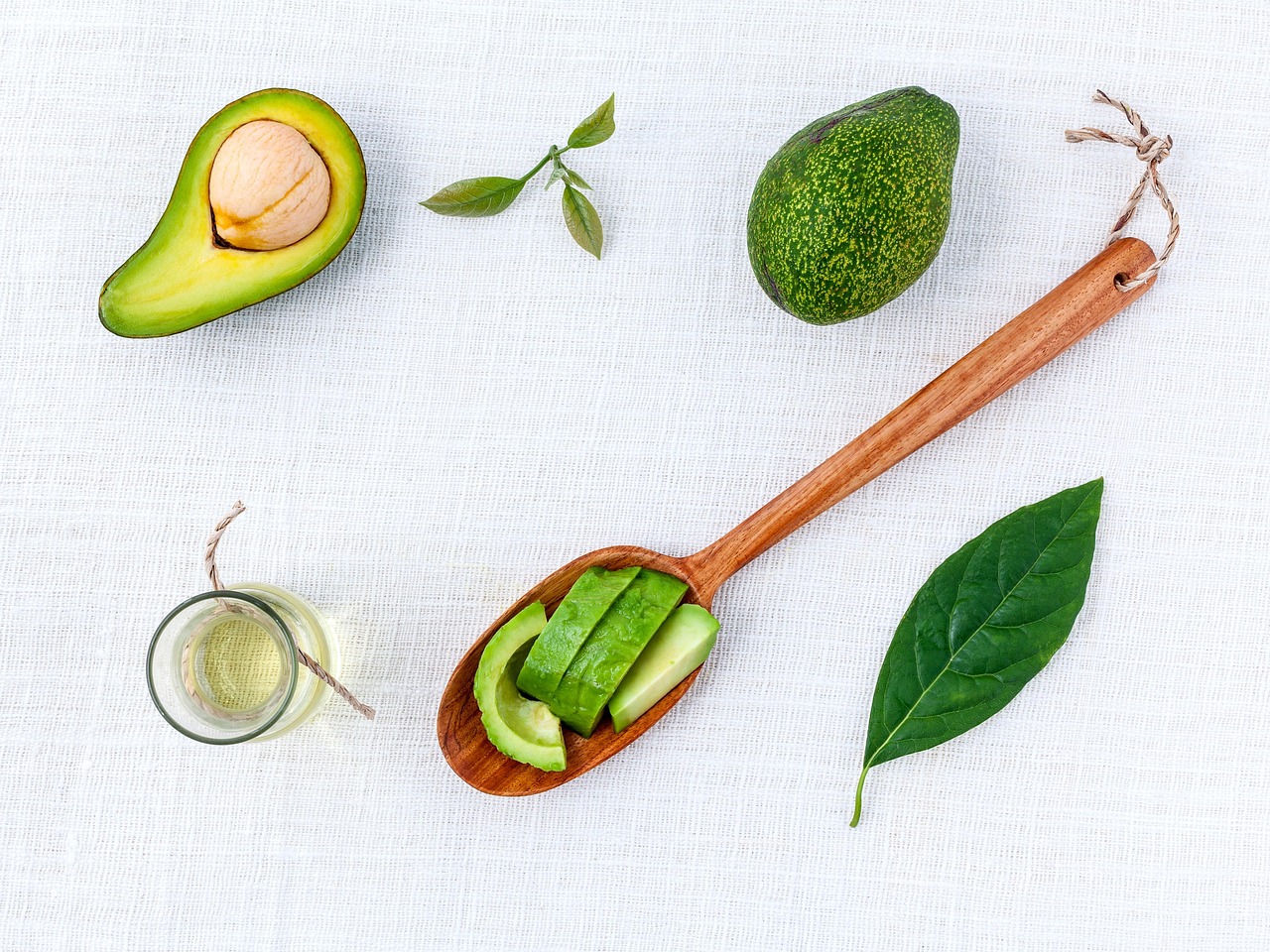 A fresh avocado next to a blurry nutrition facts label to represent the choice between real food and processed substances.