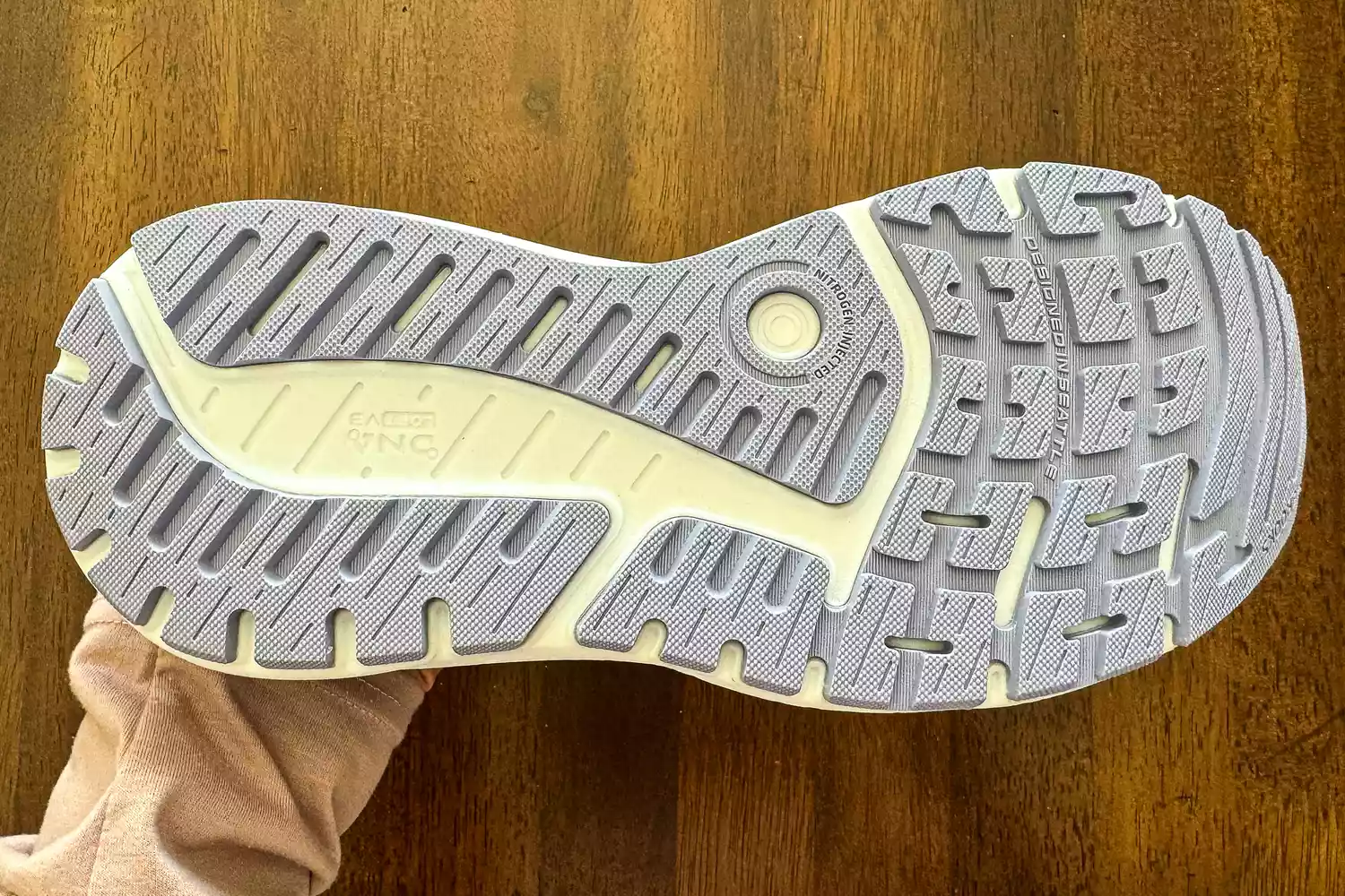 The underside of a Brooks running shoe sole highlighting nitrogen-infused cushioning and tread pattern.