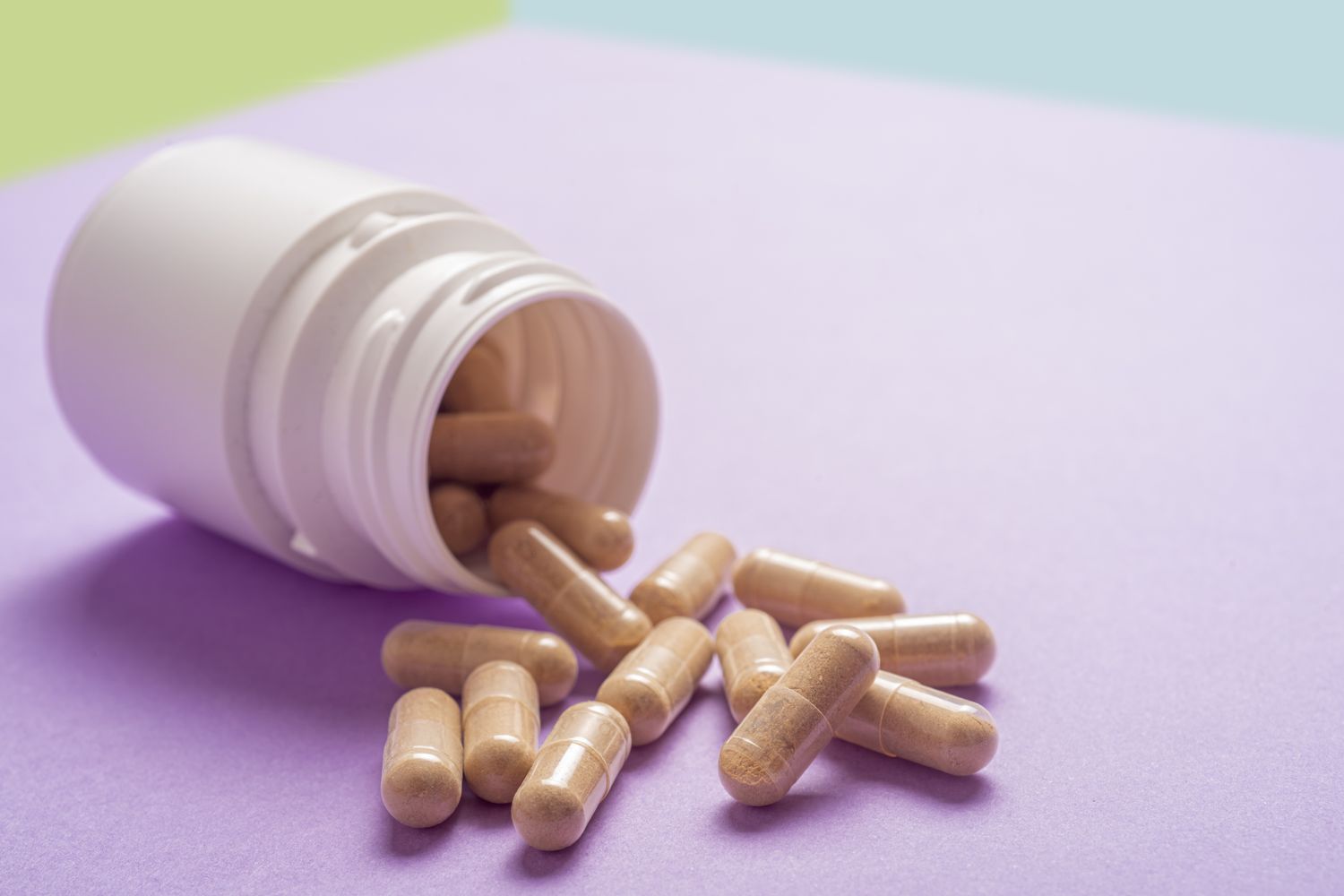 Medical capsules on a clean surface illustrating oral GLP-1 delivery methods.