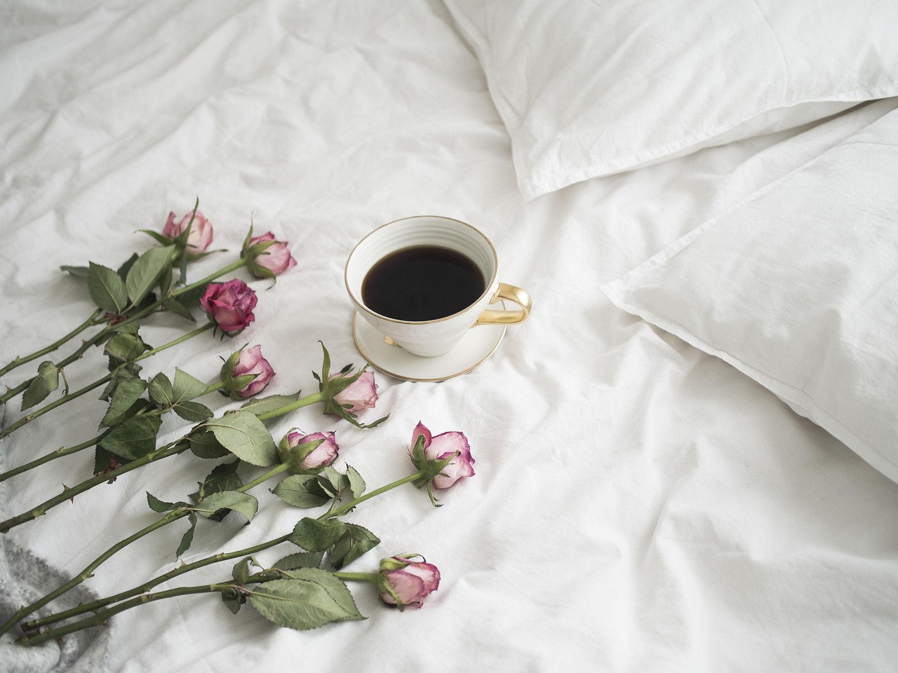 Dried rose petals and aromatic chai spices spread on a table