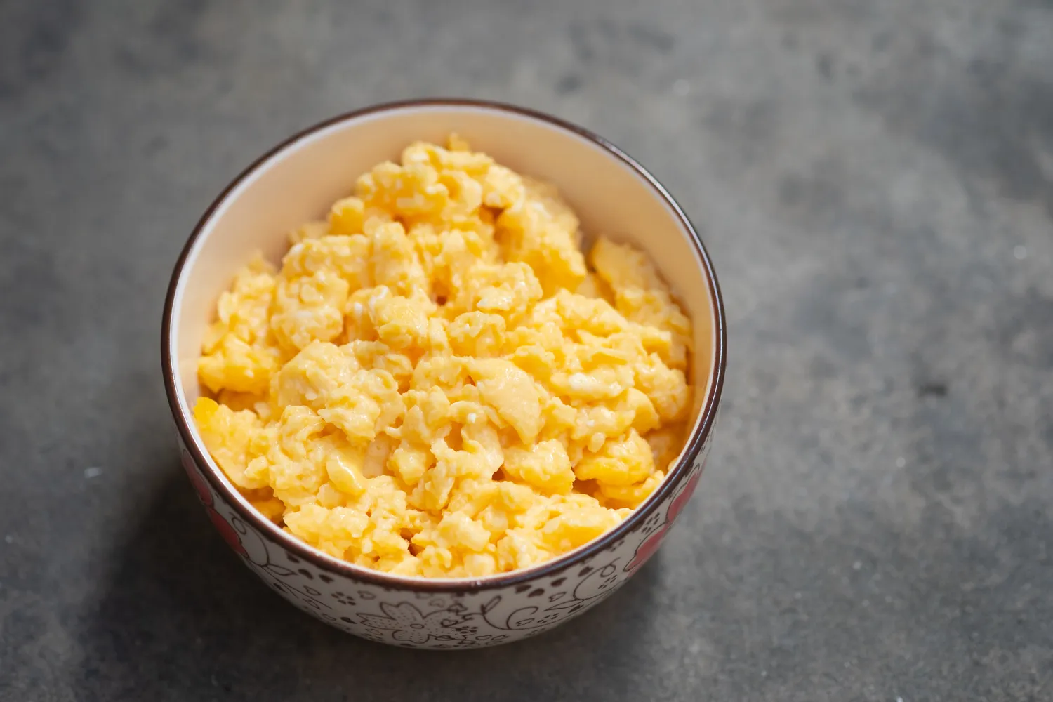 Fluffy scrambled eggs on a plate.