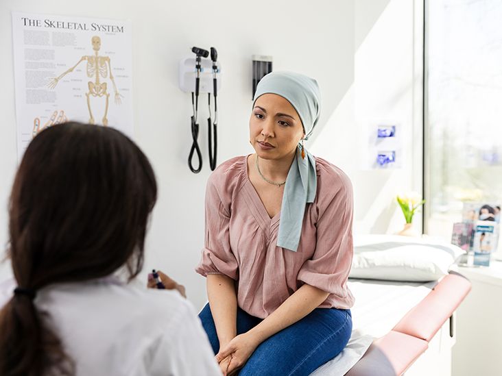 A person reviewing medical documents and insurance paperwork related to fertility coverage.